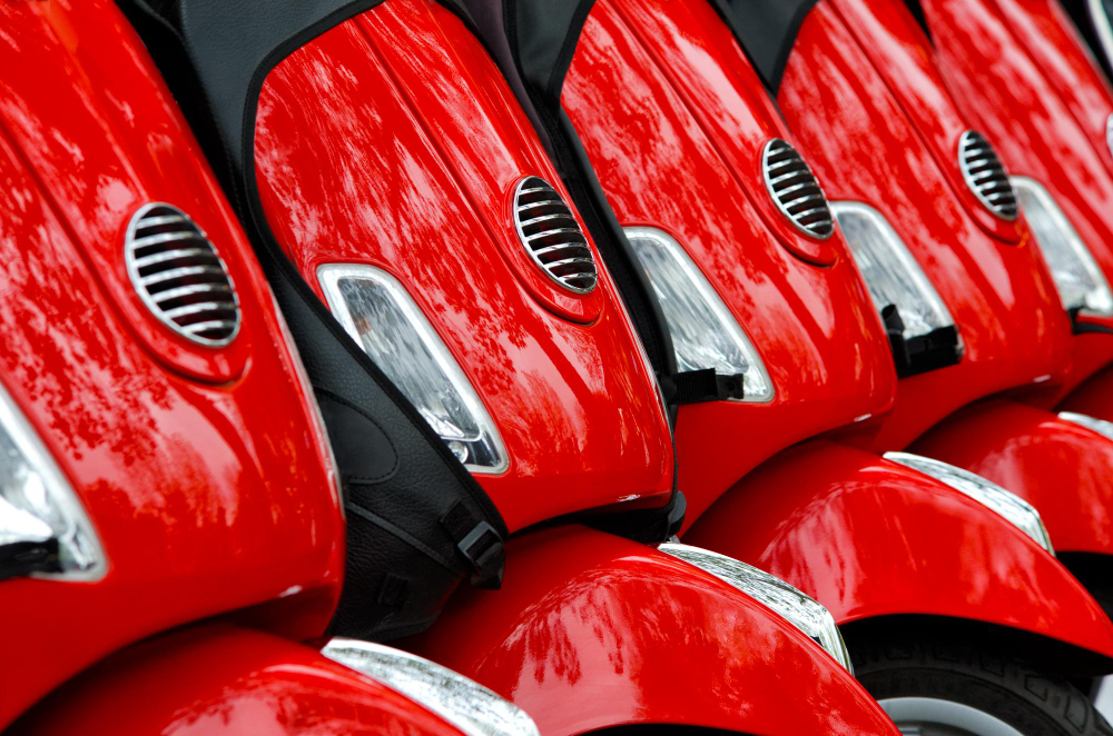 Row of rental scooters parked and ready