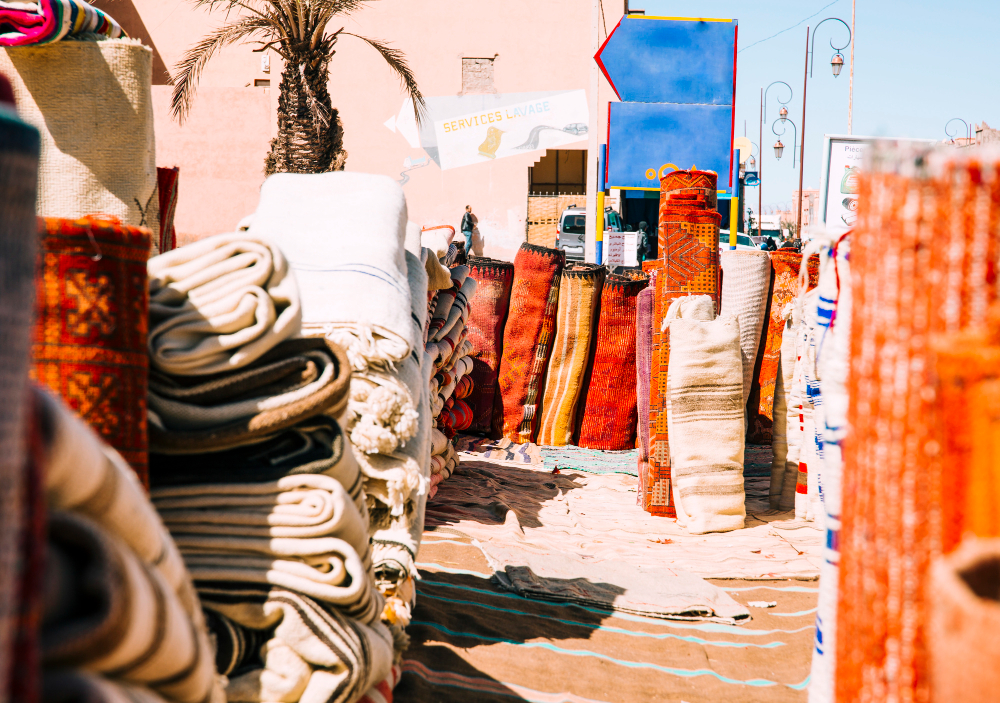 Carpets stacked and hanging in a Marrakech souk