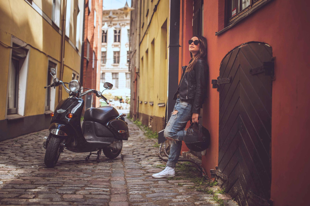 Scooter parked near an old wall