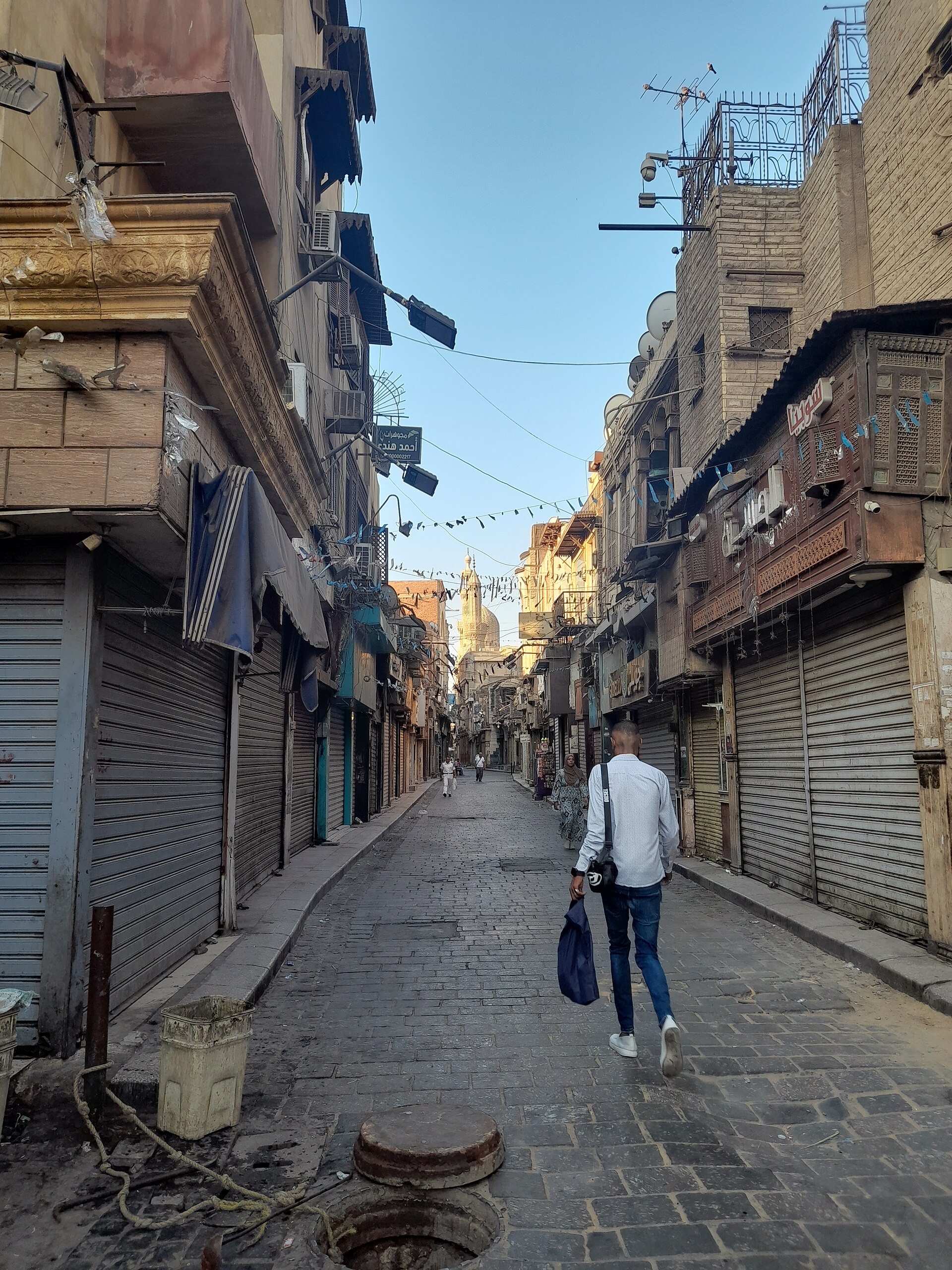 Medieval stone facades and minarets along Al-Muizz Street in Islamic Cairo