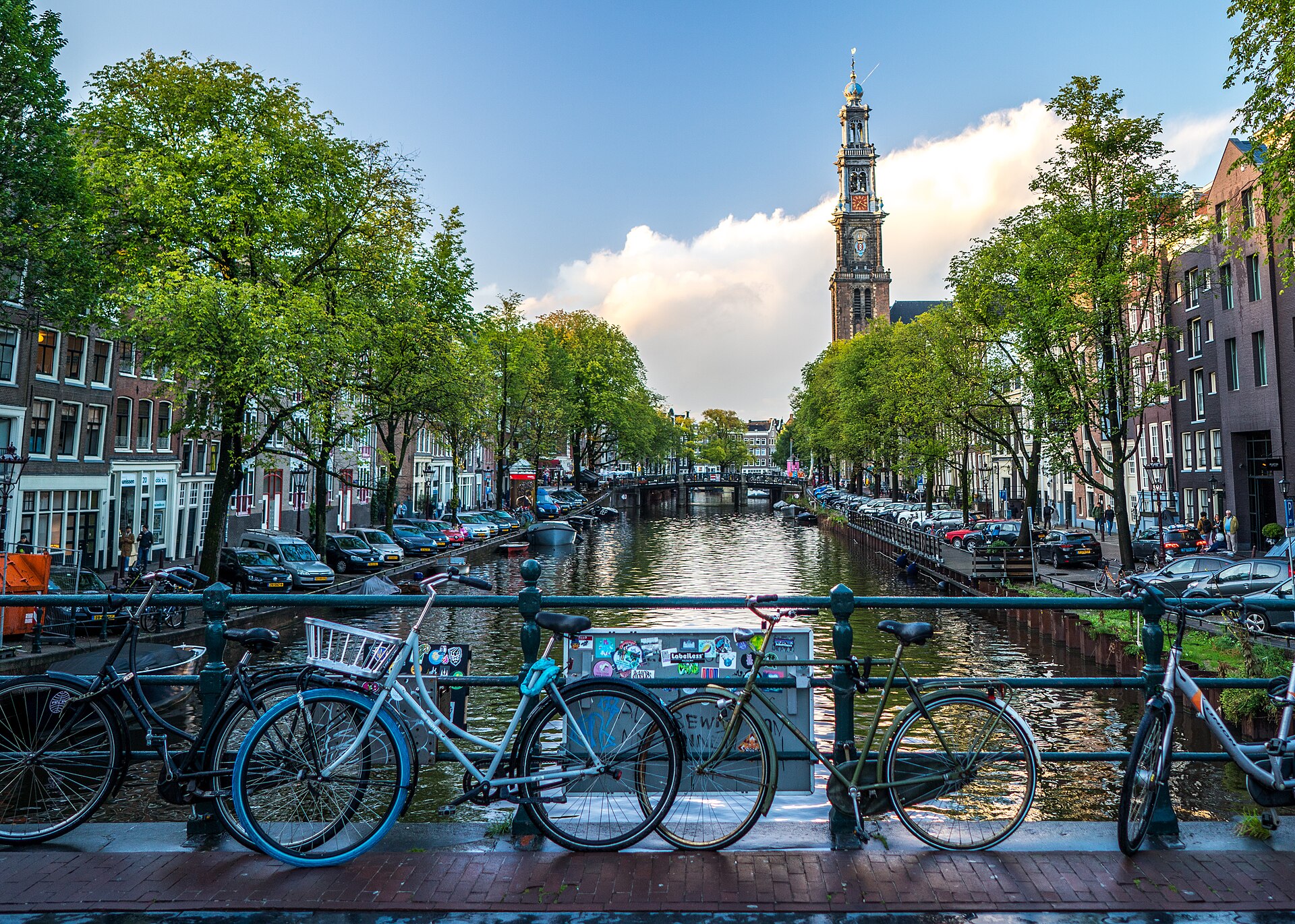 Rental bicycles locked along a canal bridge railing in central Amsterdam