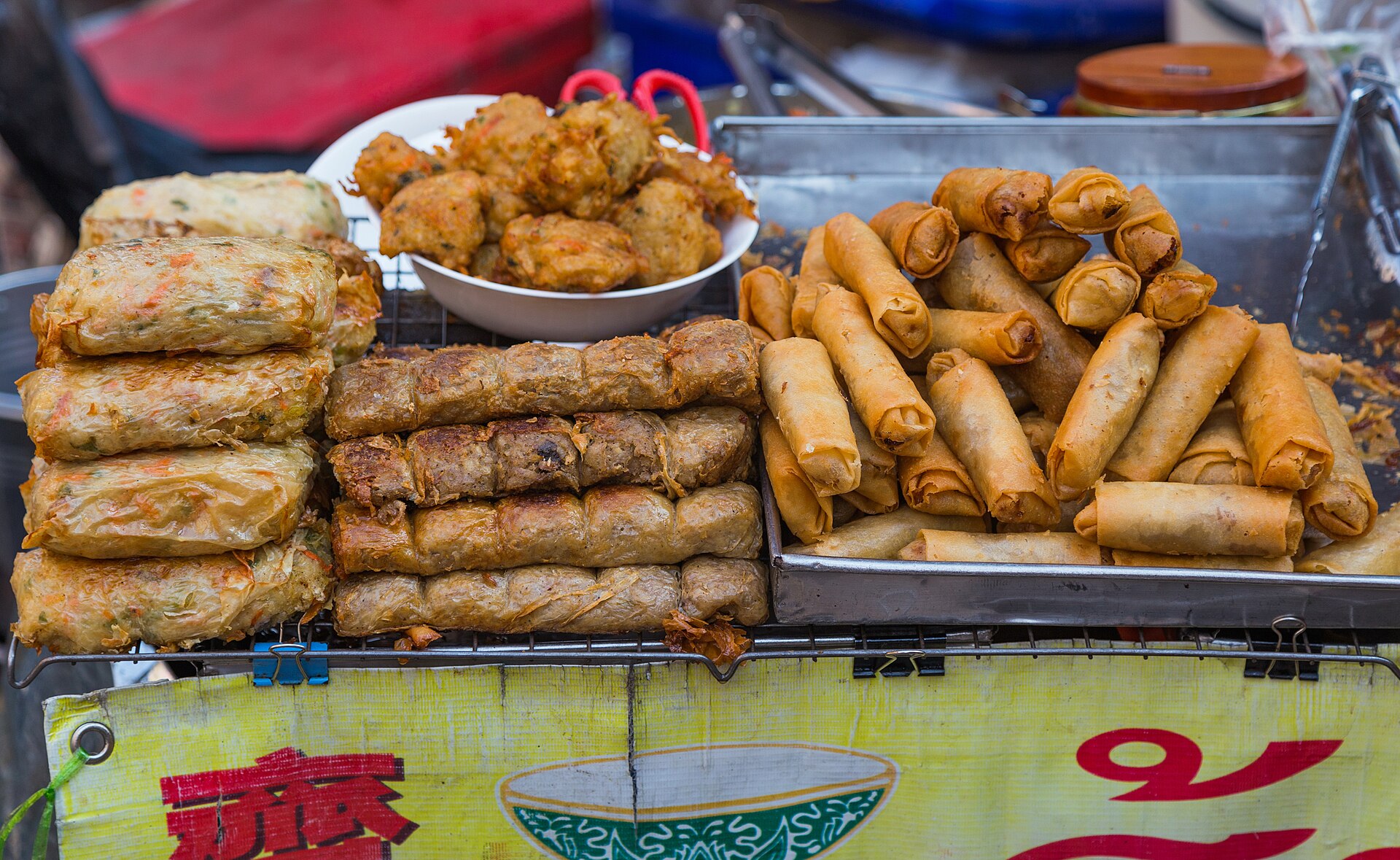 Street food stalls cooking on Yaowarat Road in Bangkok Chinatown after dark