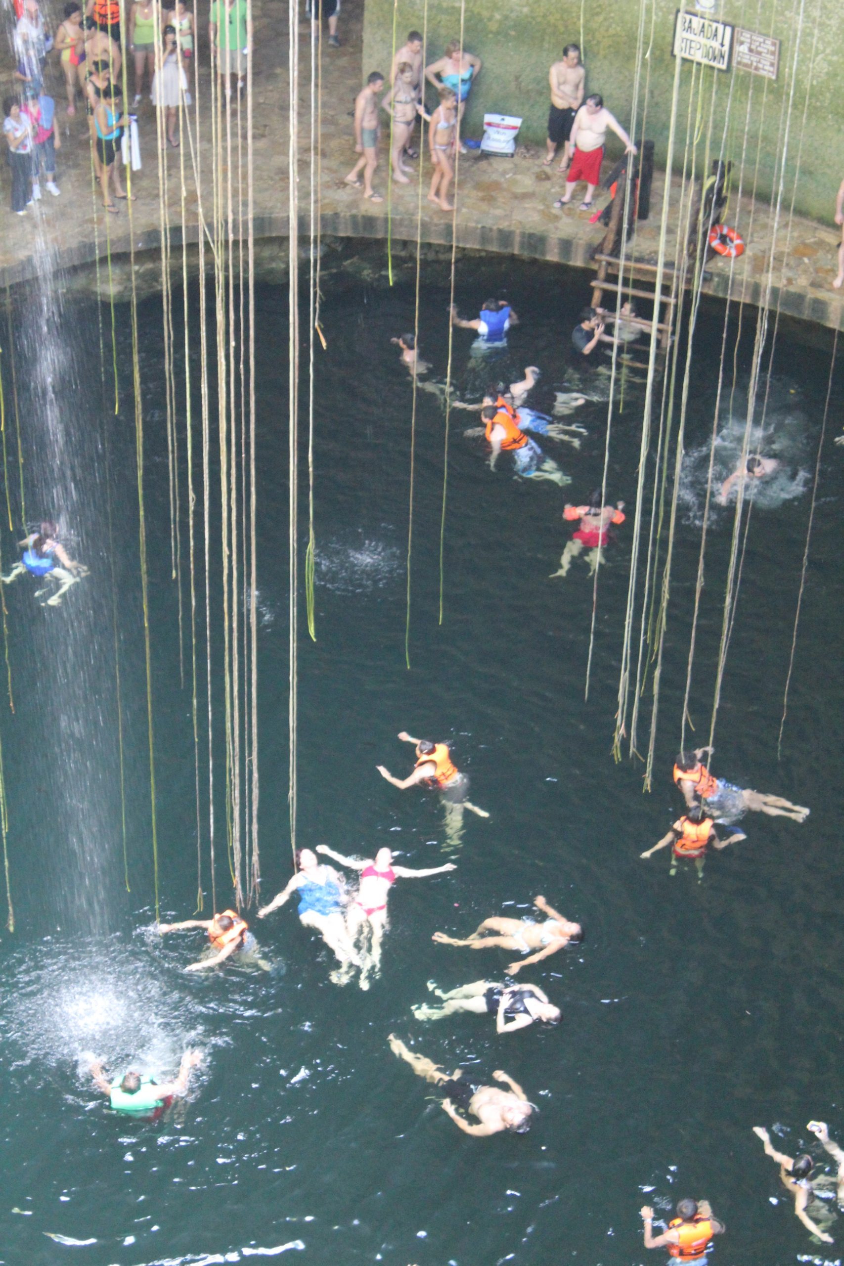 Swimmers in the open cenote Ik Kil in Yucatan