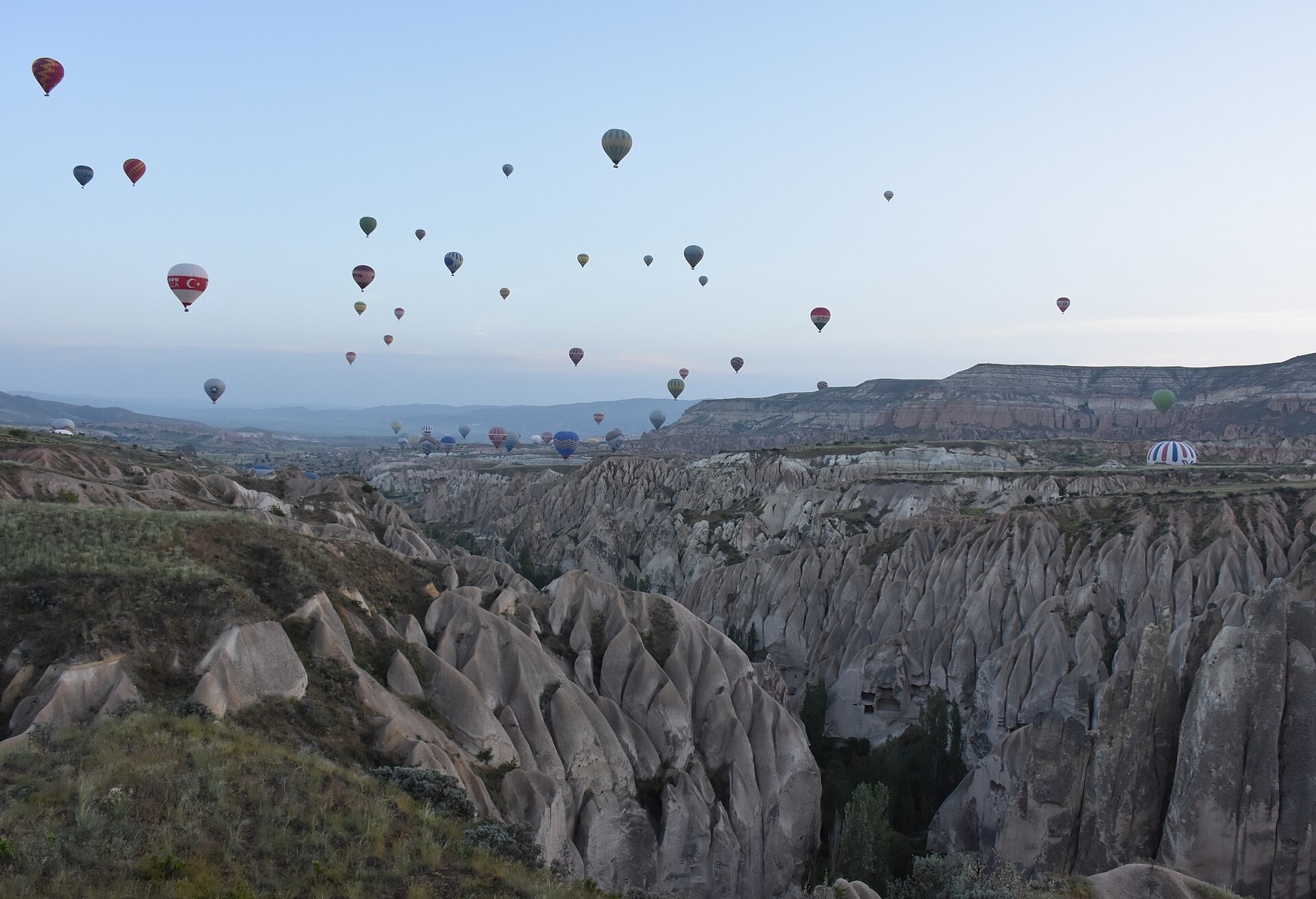Hot air balloons over the valleys near Goreme in Cappadocia at dawn