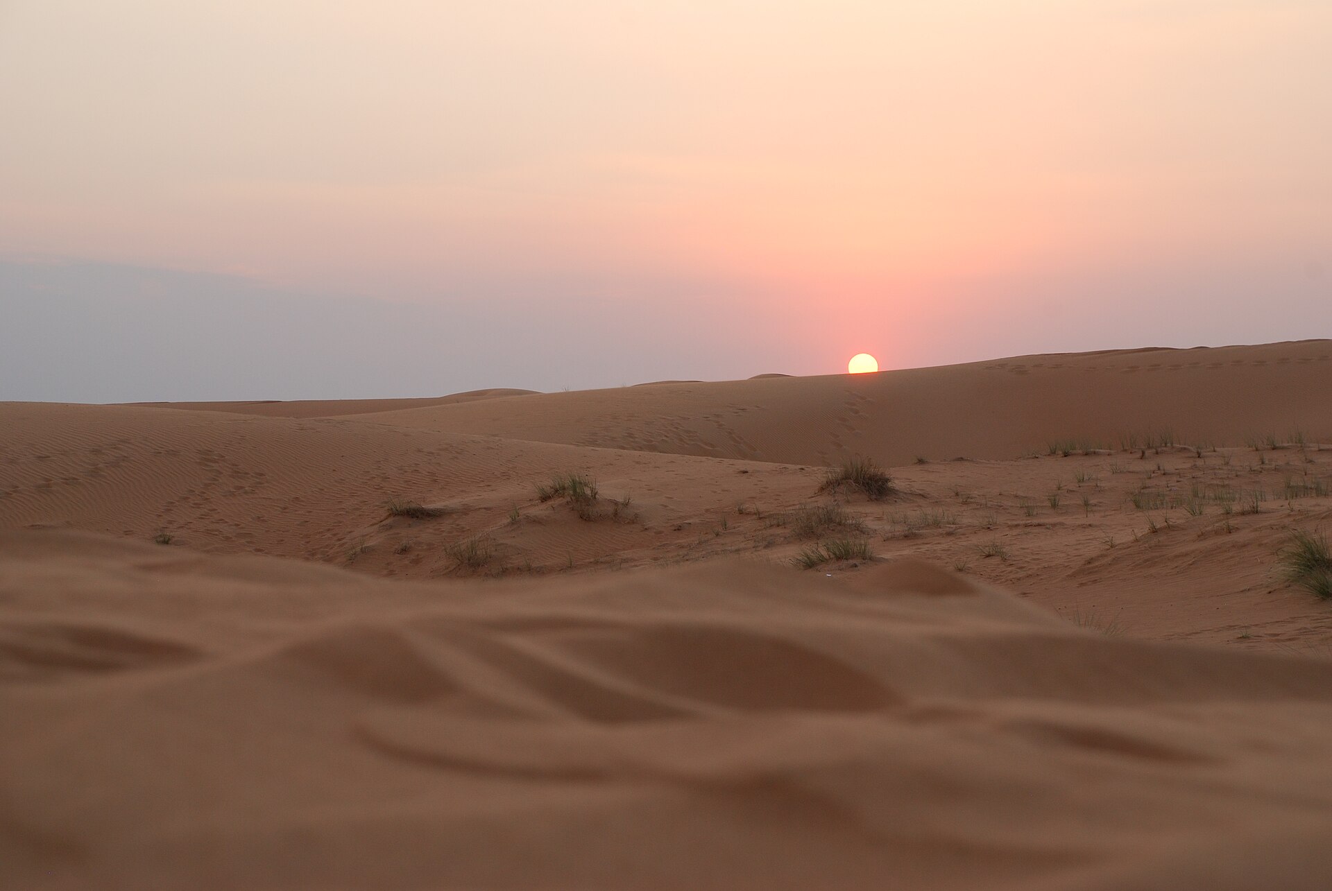Sunset over sand dunes in the desert outside Dubai