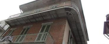 Historic street with iron balconies in the French Quarter, New Orleans