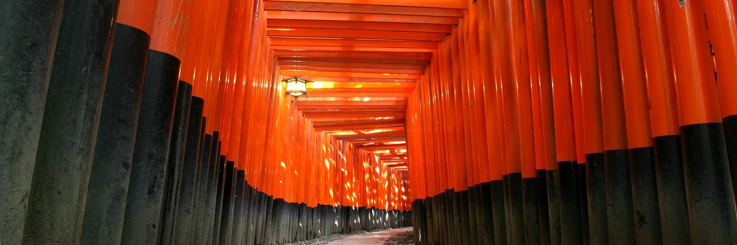 Rows of vermilion torii gates on the hillside path at Fushimi Inari shrine in southern Kyoto