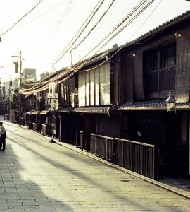 Traditional wooden machiya townhouses lining a narrow street in the Gion district of Kyoto