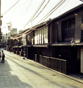 Traditional wooden machiya townhouses lining a narrow street in the Gion district of Kyoto
