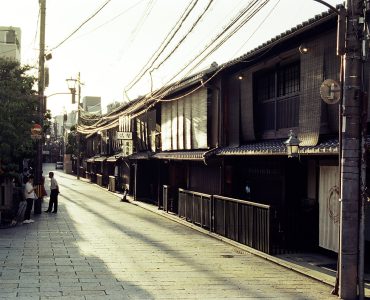 Traditional wooden machiya townhouses lining a narrow street in the Gion district of Kyoto