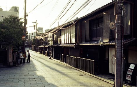 Traditional wooden machiya townhouses lining a narrow street in the Gion district of Kyoto