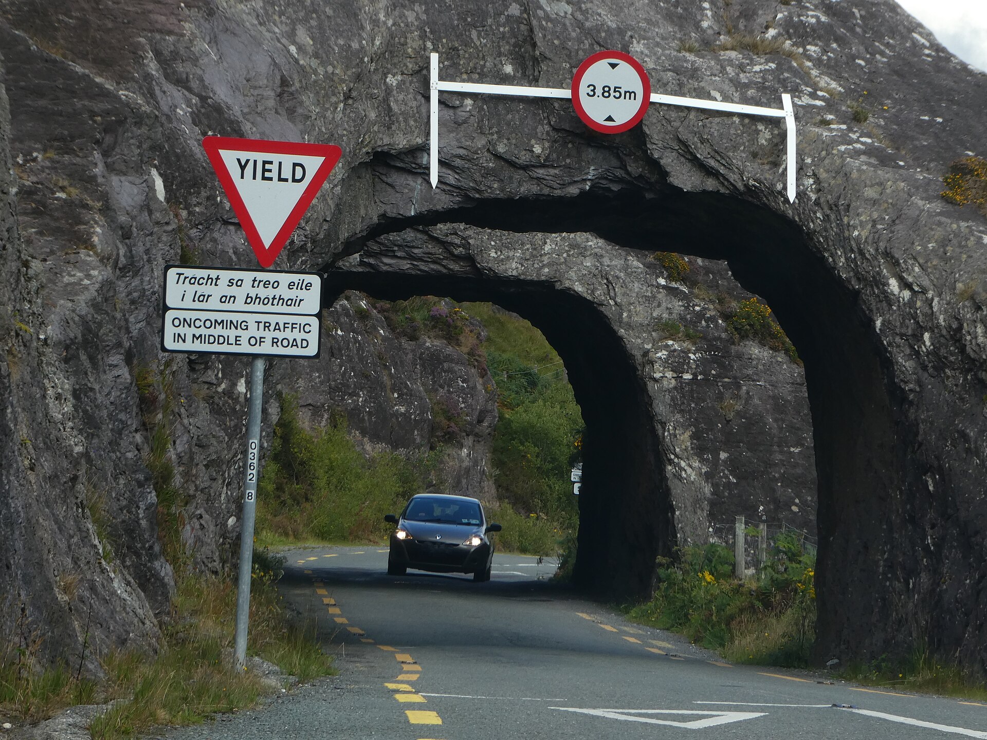 Warning signs on a narrow mountain road through the Caha Mountains in County Cork