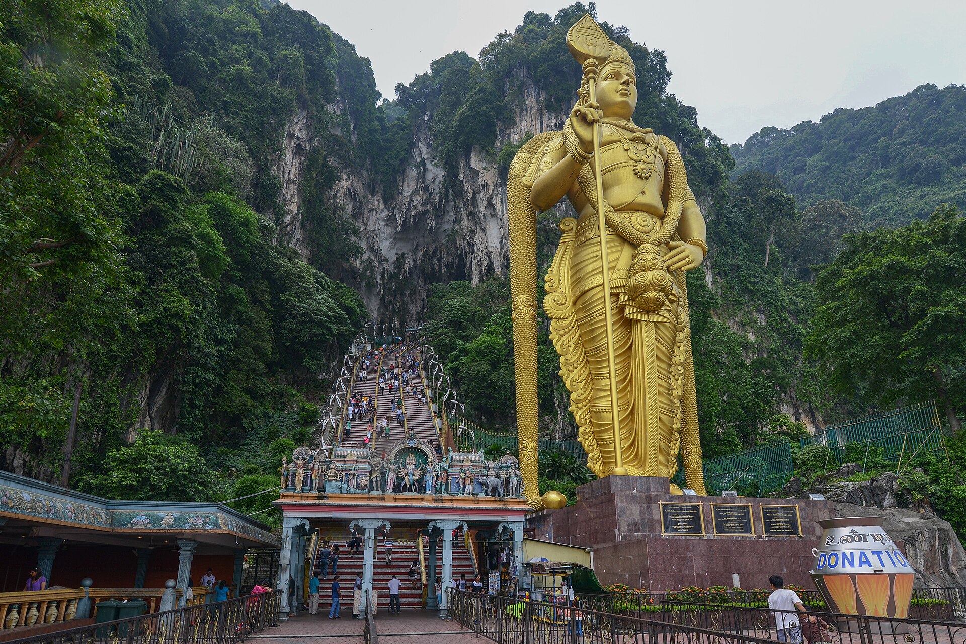 The 272 coloured steps at Batu Caves beside the 43-metre golden statue of Lord Murugan
