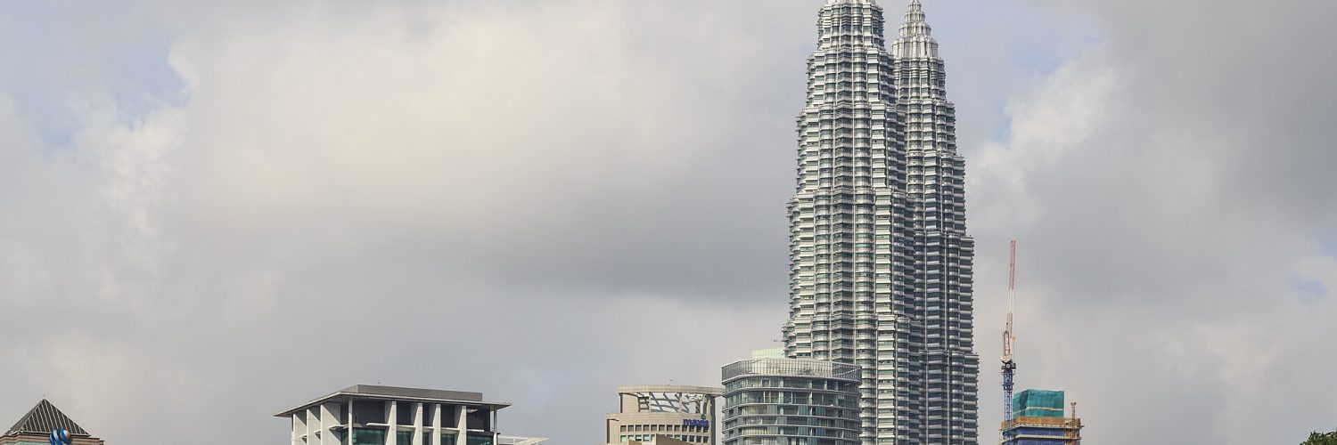The Petronas Twin Towers rising above the KLCC district in Kuala Lumpur