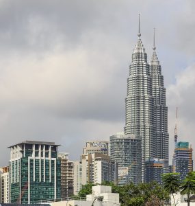 The Petronas Twin Towers rising above the KLCC district in Kuala Lumpur