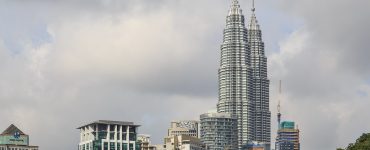 The Petronas Twin Towers rising above the KLCC district in Kuala Lumpur