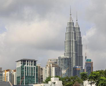 The Petronas Twin Towers rising above the KLCC district in Kuala Lumpur