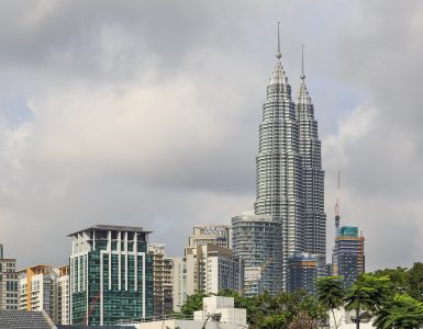 The Petronas Twin Towers rising above the KLCC district in Kuala Lumpur