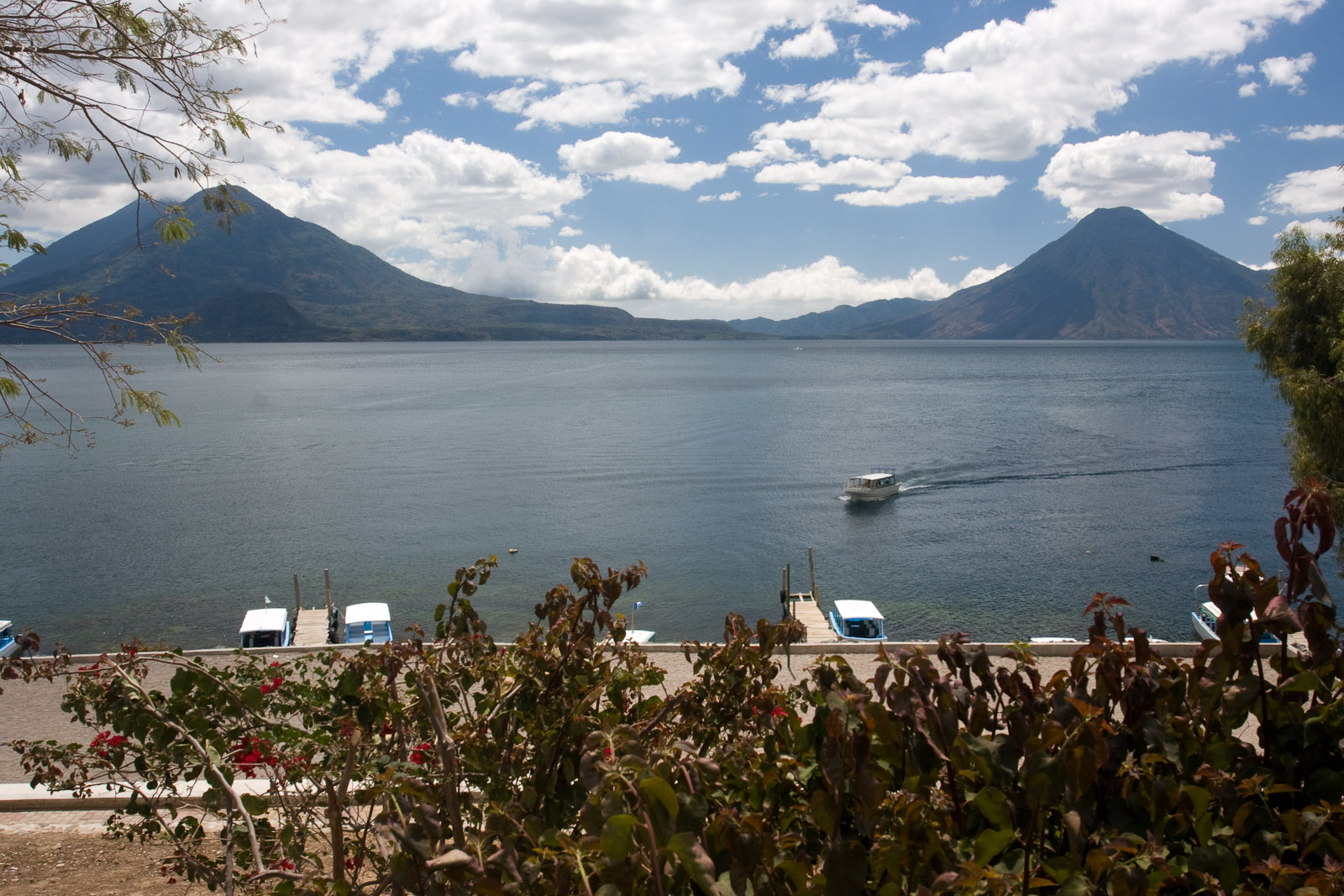 Lake Atitlan and its volcanoes seen from the shore at Panajachel