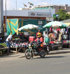 A boda boda motorcycle taxi rider waiting on a street in Nairobi