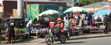 A boda boda motorcycle taxi rider waiting on a street in Nairobi