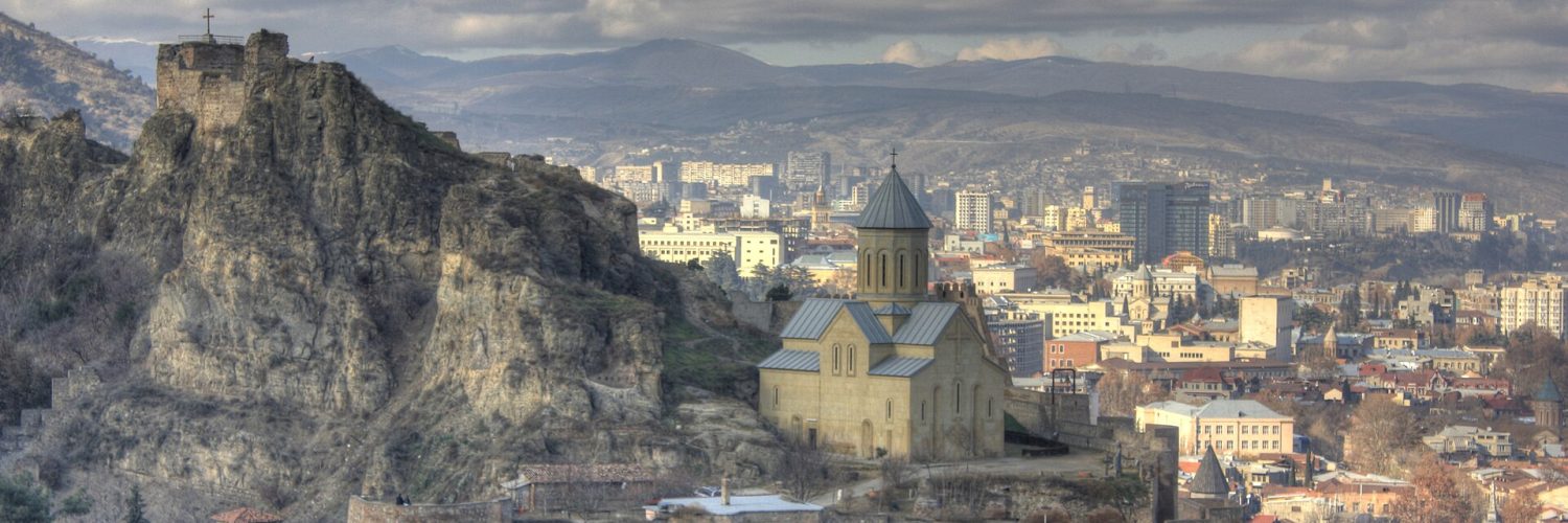 The stone walls of Narikala fortress above Tbilisi with the city spread out below