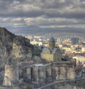 The stone walls of Narikala fortress above Tbilisi with the city spread out below