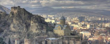 The stone walls of Narikala fortress above Tbilisi with the city spread out below