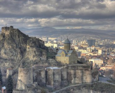 The stone walls of Narikala fortress above Tbilisi with the city spread out below