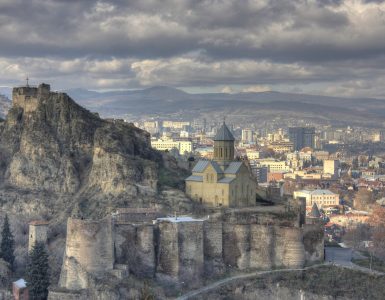 The stone walls of Narikala fortress above Tbilisi with the city spread out below