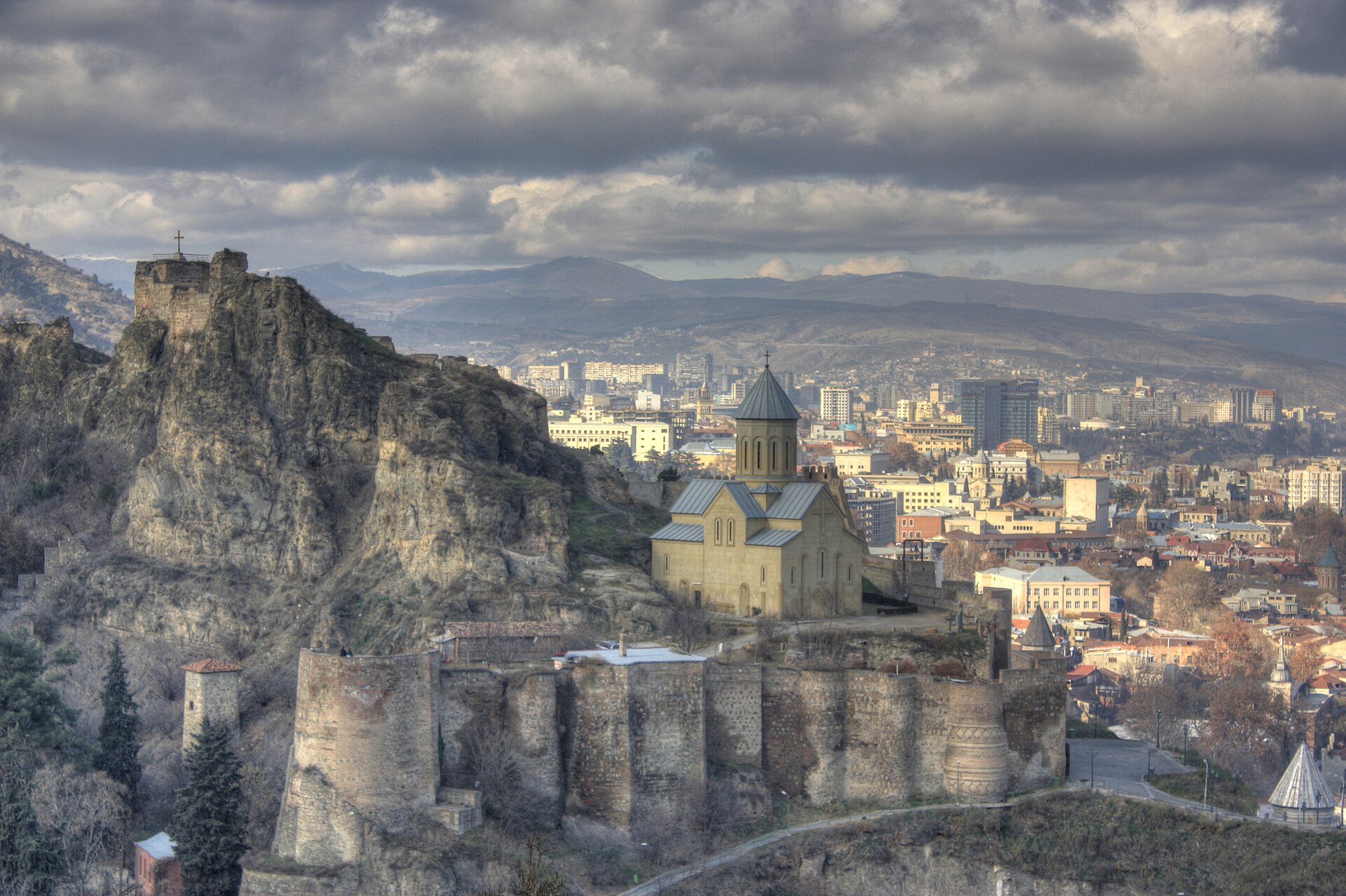 The stone walls of Narikala fortress above Tbilisi with the city spread out below