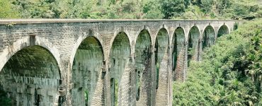 The stone Nine Arch Bridge curving through jungle at Ella, Sri Lanka