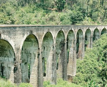 The stone Nine Arch Bridge curving through jungle at Ella, Sri Lanka