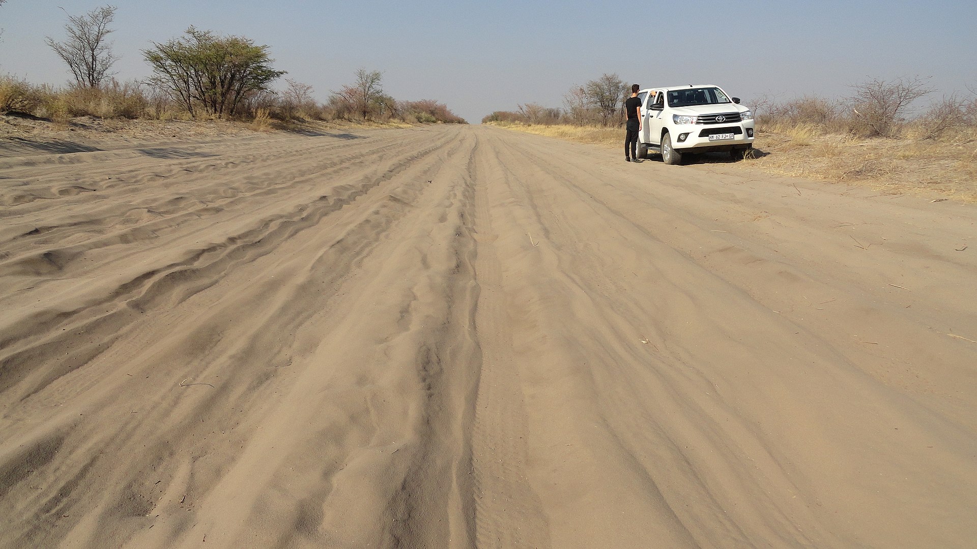 A deep sand track leading across Nxai Pan towards Baines' Baobabs in Botswana