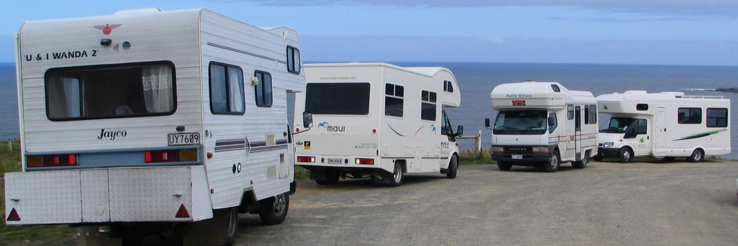 A campervan parked with a view over the New Zealand landscape