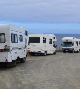 A campervan parked with a view over the New Zealand landscape