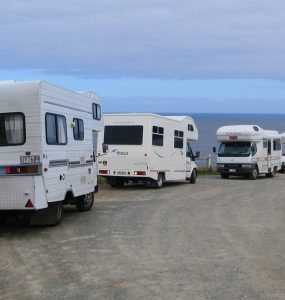 A campervan parked with a view over the New Zealand landscape