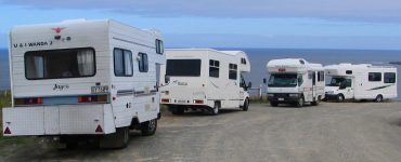 A campervan parked with a view over the New Zealand landscape