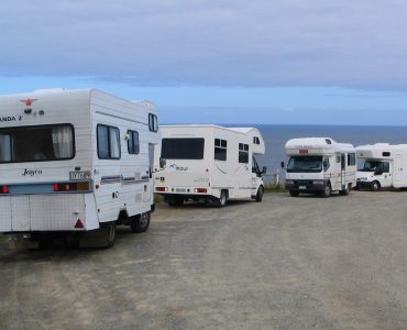 A campervan parked with a view over the New Zealand landscape