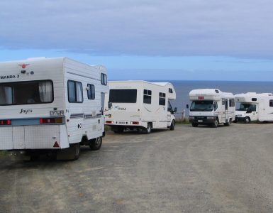 A campervan parked with a view over the New Zealand landscape