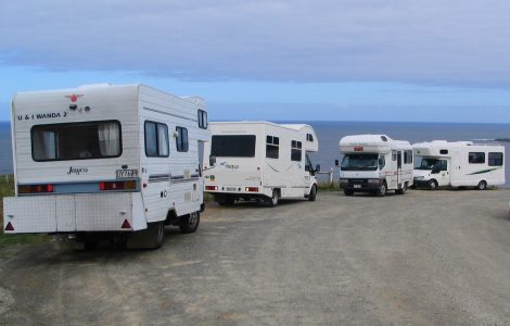 A campervan parked with a view over the New Zealand landscape
