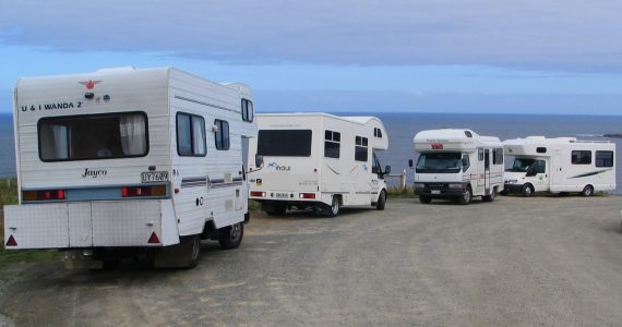 A campervan parked with a view over the New Zealand landscape