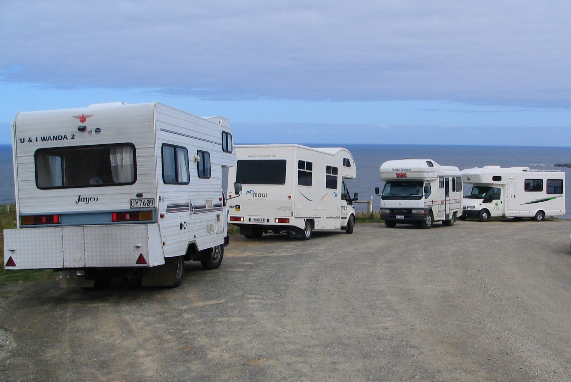 A campervan parked with a view over the New Zealand landscape