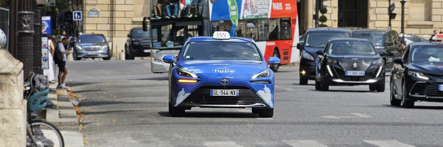 A licensed Paris taxi, a hydrogen Toyota Mirai, on a city street