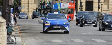 A licensed Paris taxi, a hydrogen Toyota Mirai, on a city street