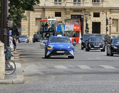 A licensed Paris taxi, a hydrogen Toyota Mirai, on a city street