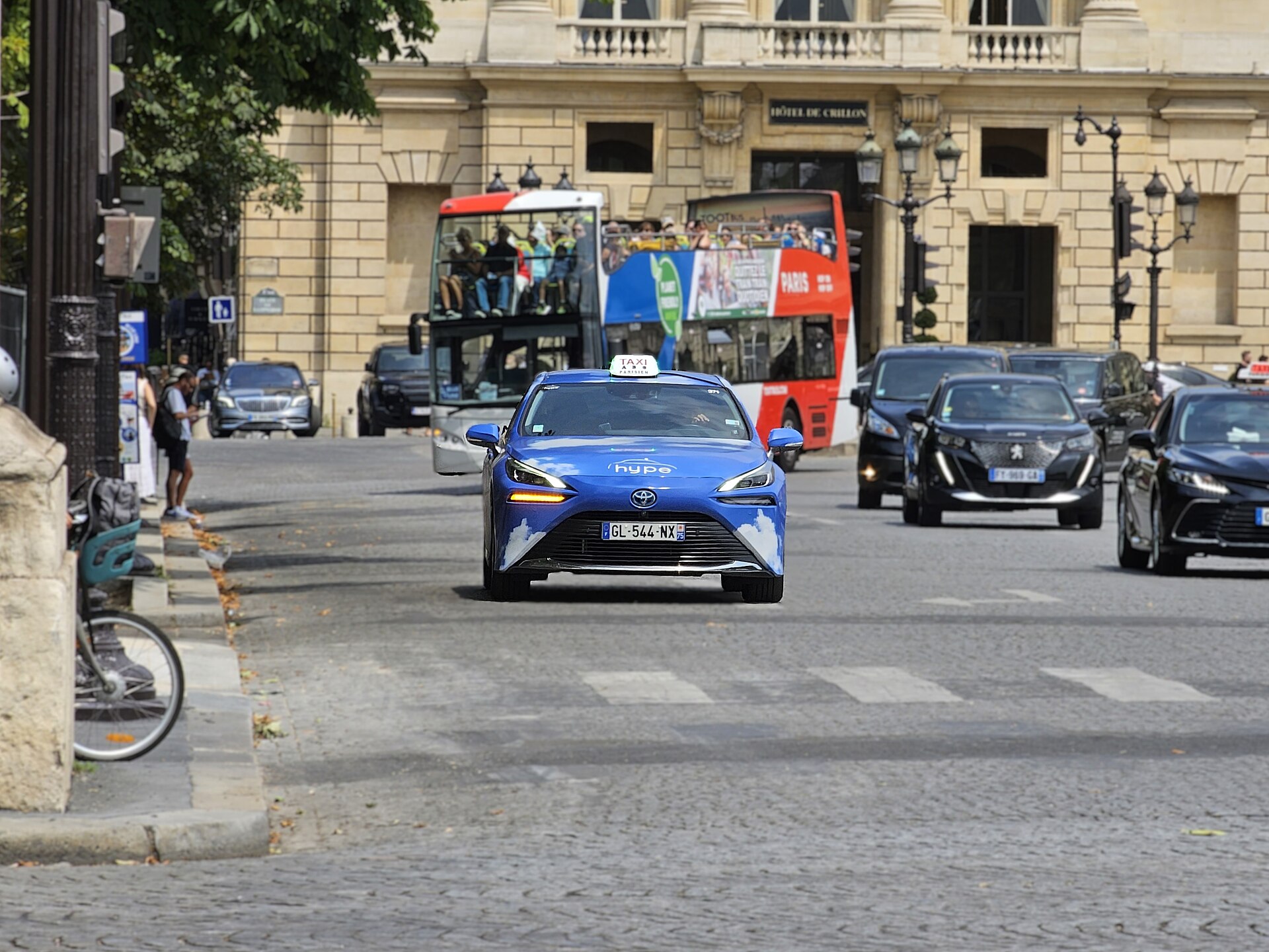 A licensed Paris taxi, a hydrogen Toyota Mirai, on a city street