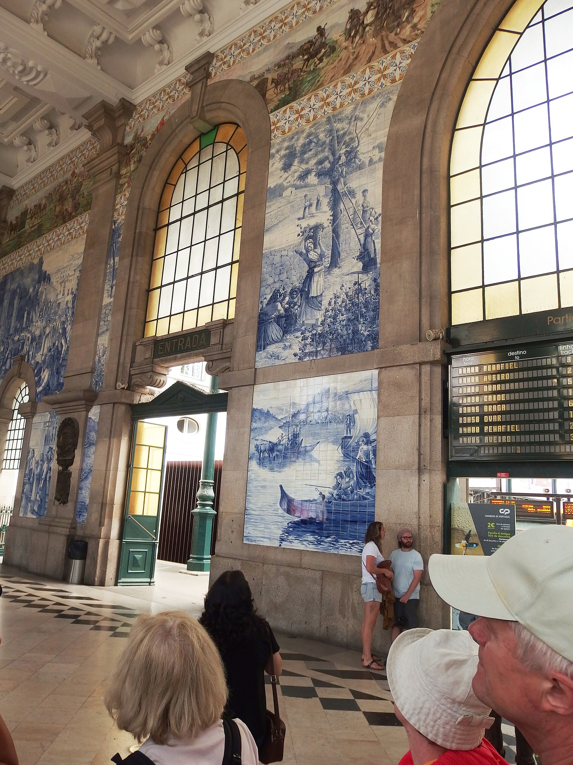 Blue and white azulejo tile panels covering the entrance hall of Sao Bento railway station in Porto