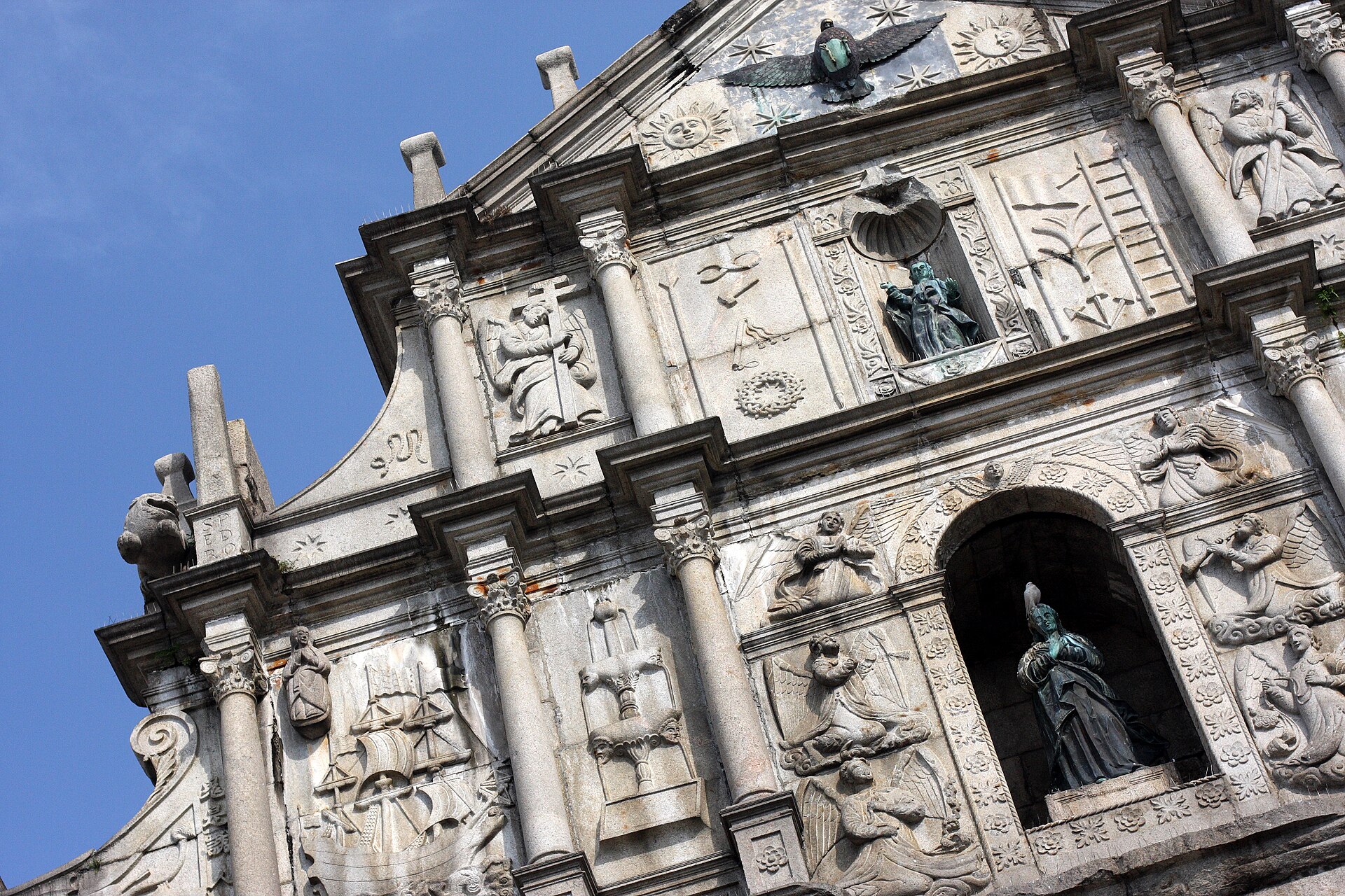 The stone facade of the Ruins of St Pauls rising above its staircase in central Macau