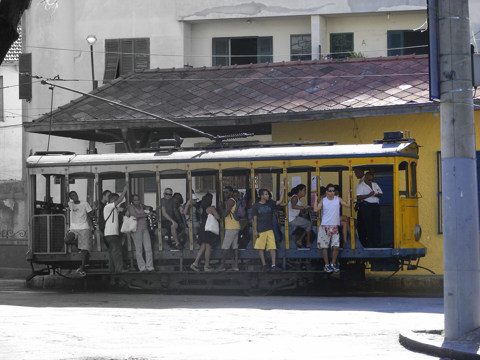 The yellow Santa Teresa bonde tram on a hillside street in Rio de Janeiro